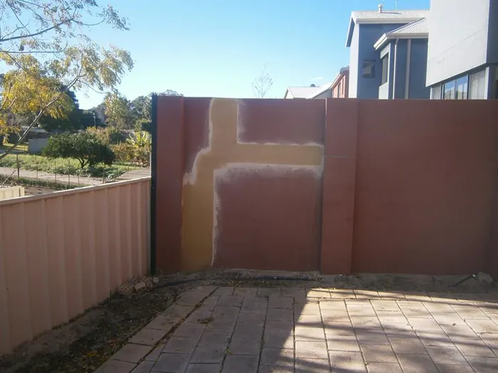 Boundary wall secured with Helifix stitching