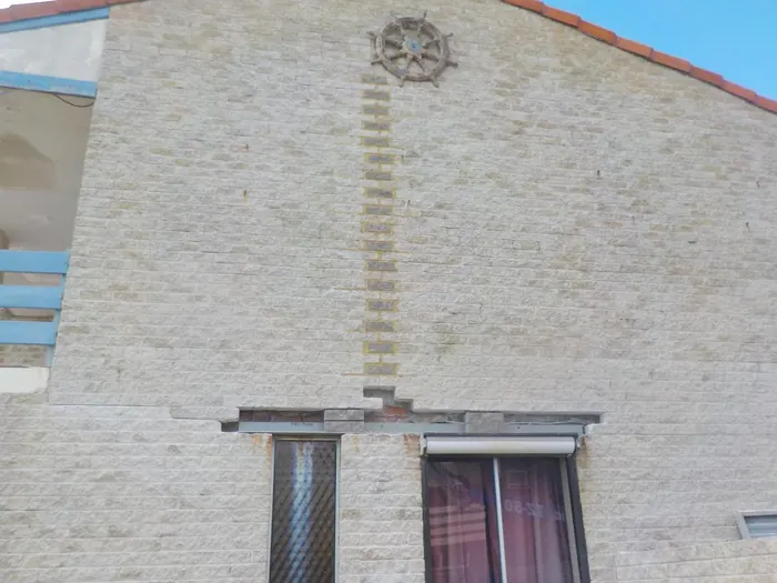 New lintels installed over windows in a cream brick apartment wall