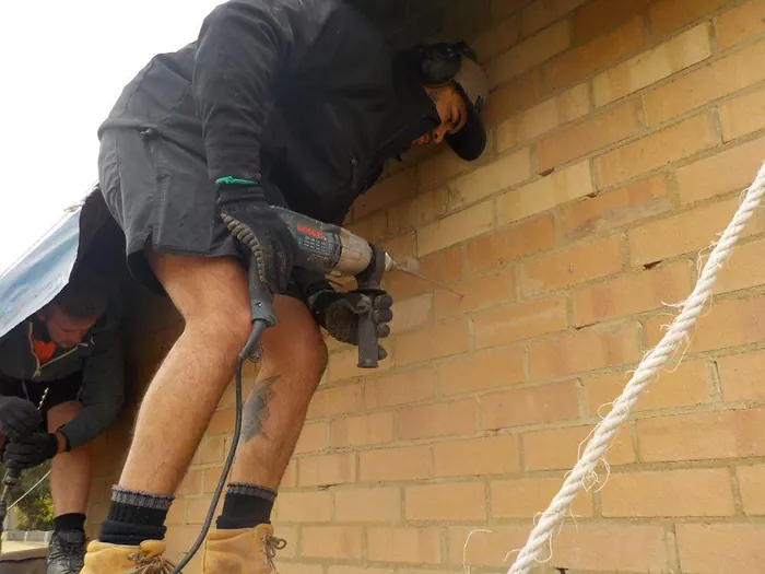 Drilling through the outer leaf for new wall ties